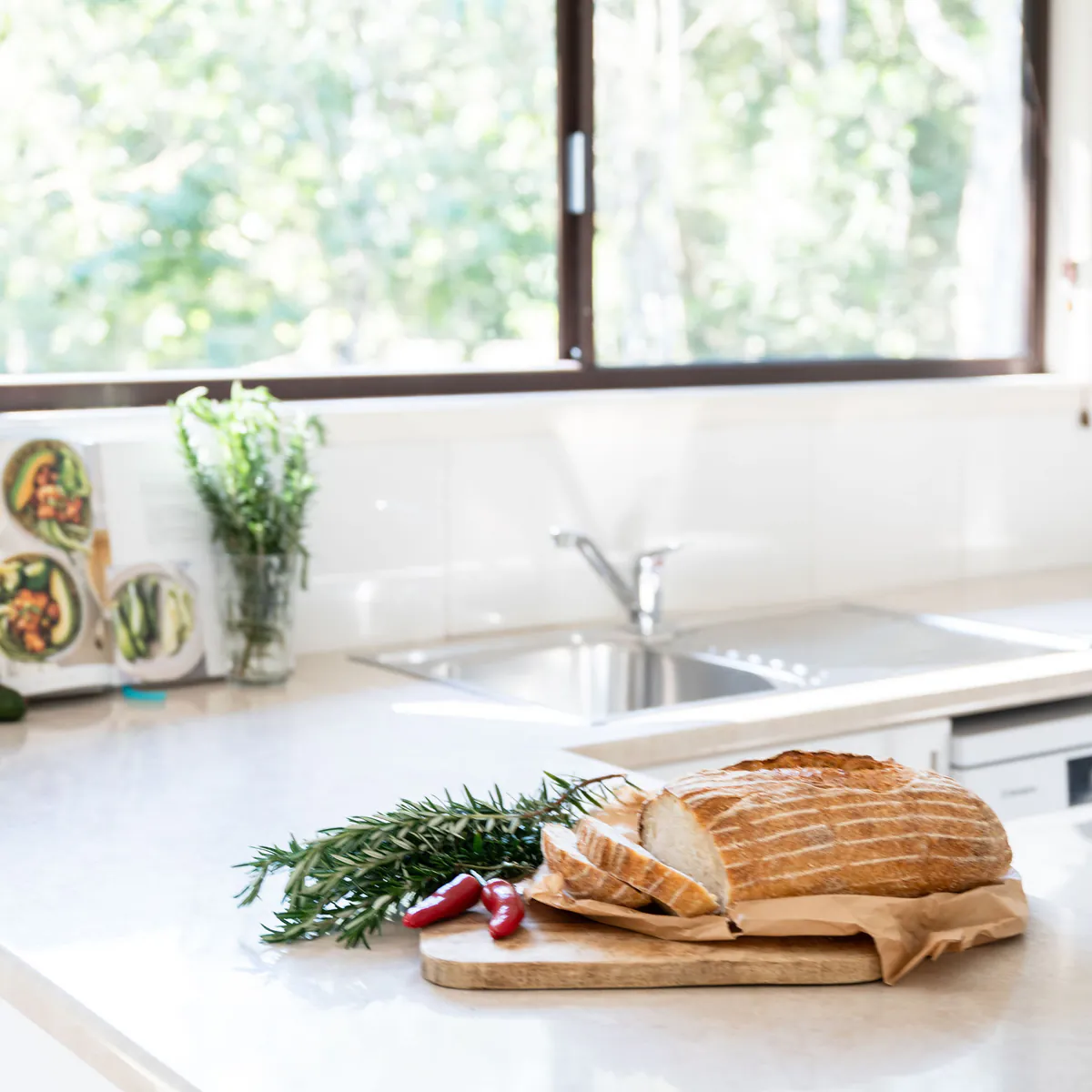 Fresh bread on the kitchen bench beside the window
